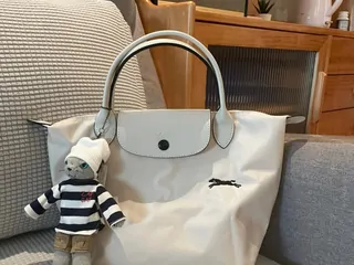 A light coloured tote bag with short handles
