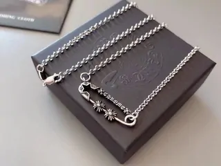 Silver-coloured chain jewellery laid on a dark box